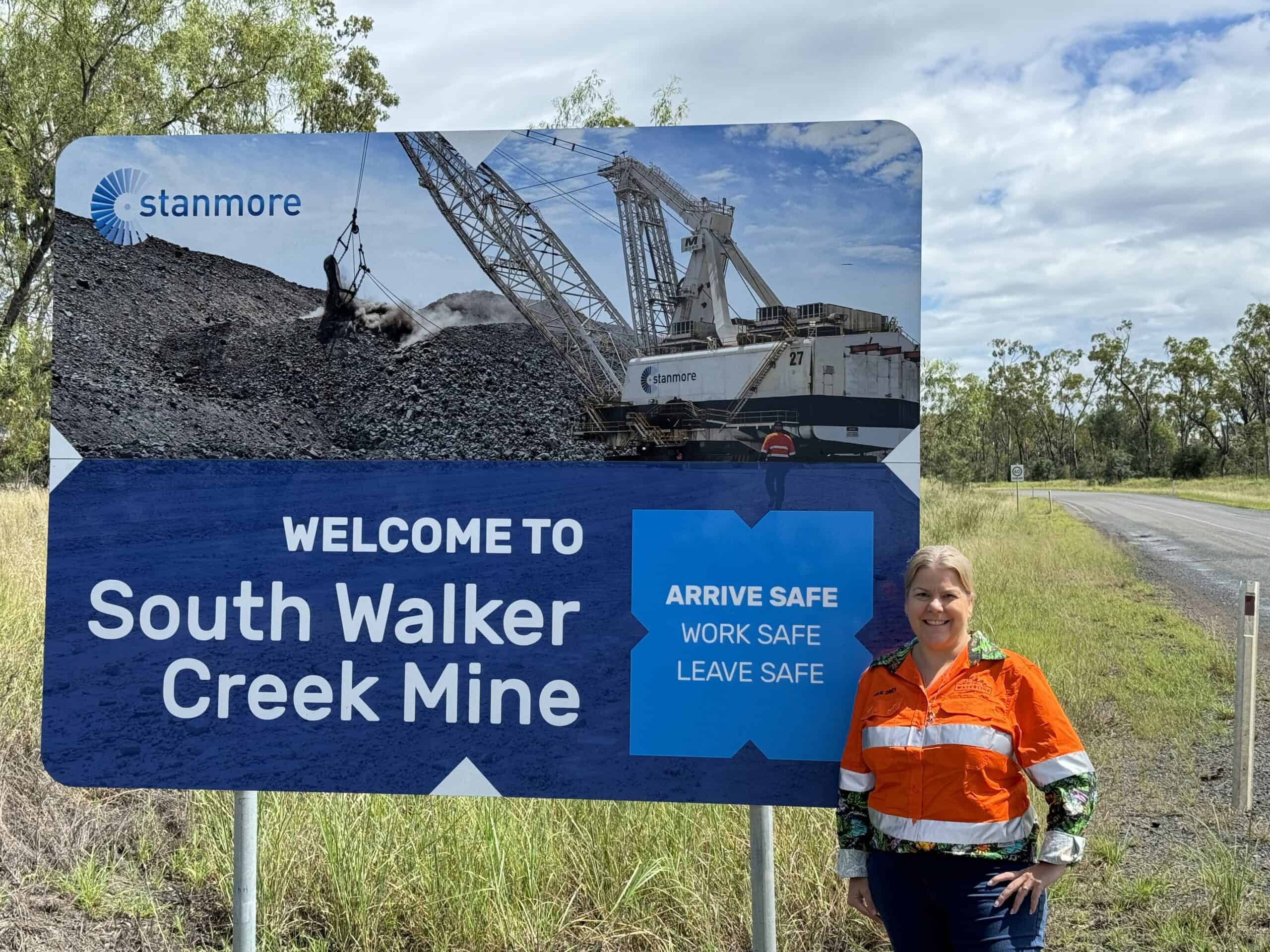 One of our experts standing by the South Walker Creek Mine welcome sign